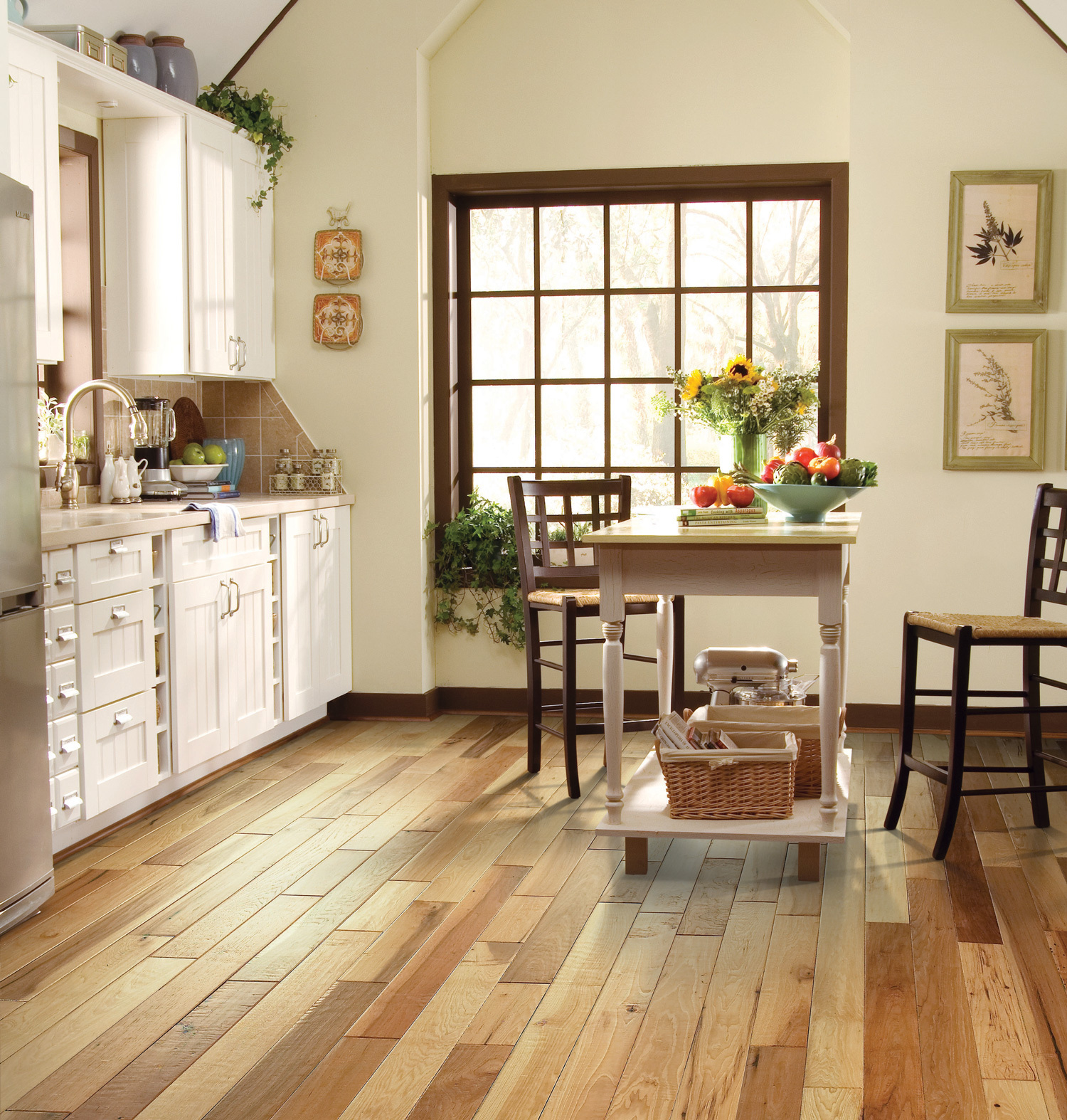 A bright kitchen featuring a rustic look and a large window onlooking some trees